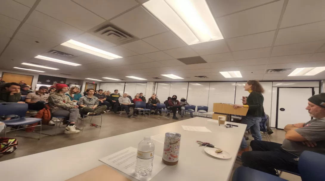 A panel of speakers addresses a group